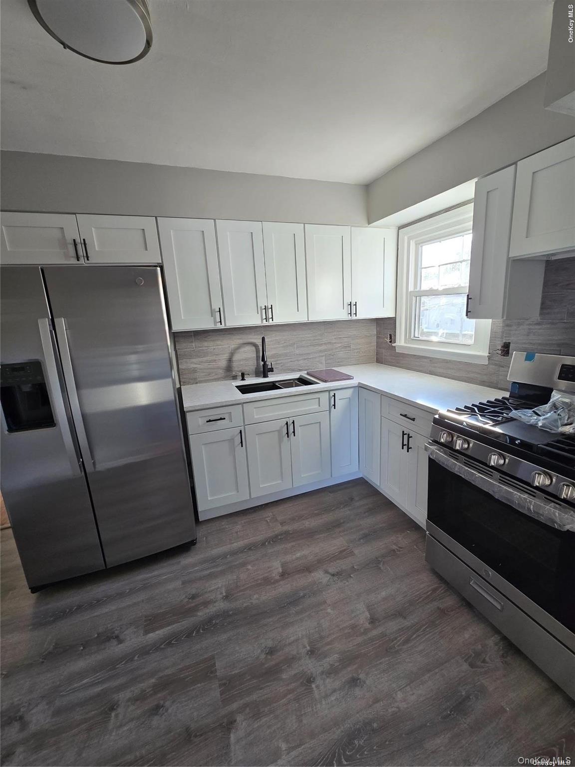 70 East Valley Stream Boulevard, Unit 2 Valley Stream, NY 11580 - Photo 1 of 1 a kitchen with stainless steel appliances granite countertop a sink a stove a refrigerator and cabinets