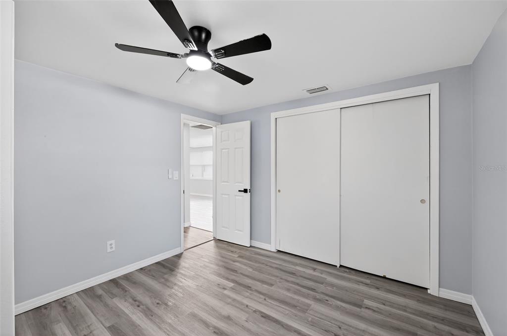 4086 Arrowhead Avenue Spring Hill, FL 34606 - Photo 12 of 21 a view of an empty room with wooden floor