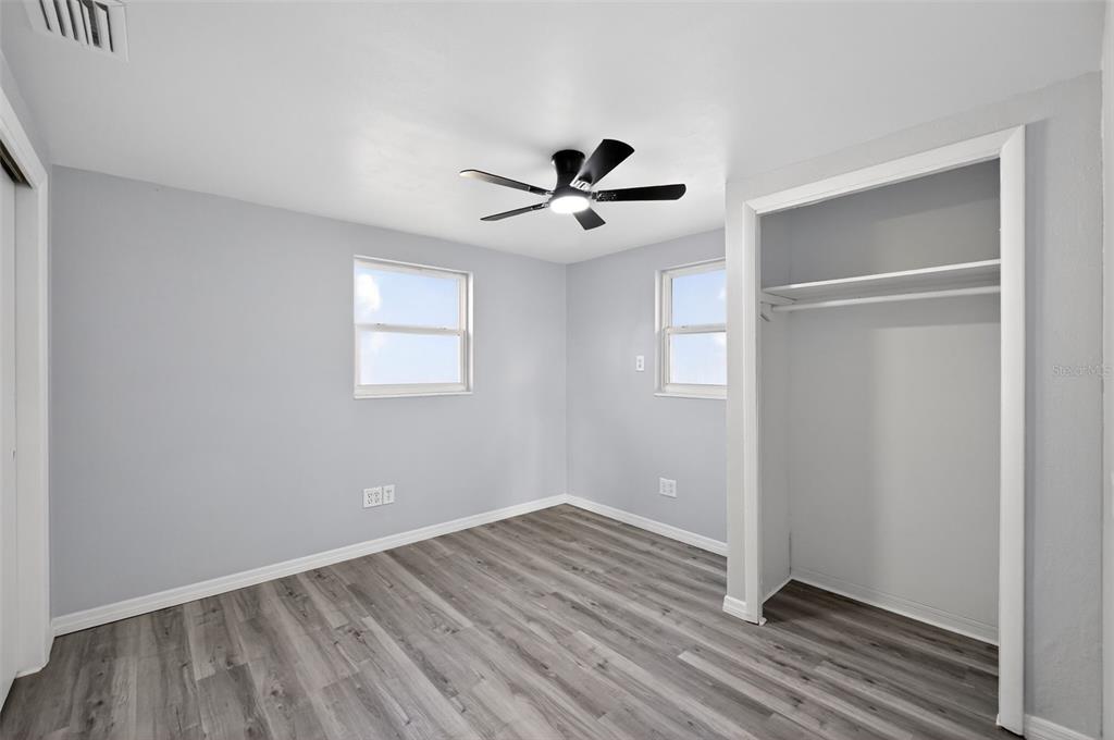 4086 Arrowhead Avenue Spring Hill, FL 34606 - Photo 13 of 21 a view of empty room with wooden floor and ceiling fan
