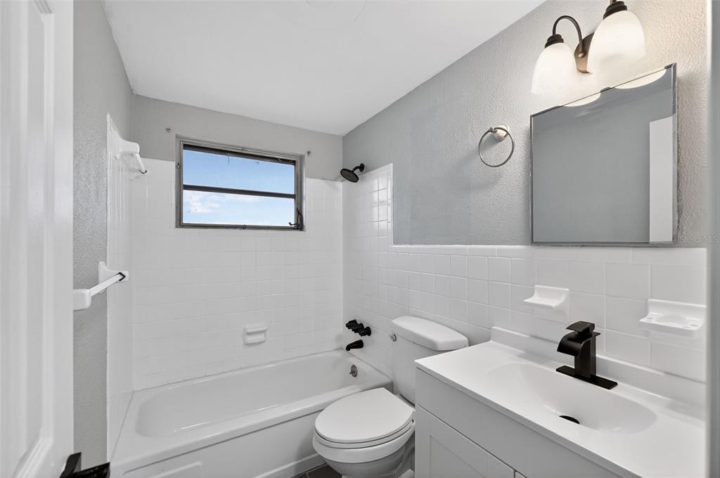 4086 Arrowhead Avenue Spring Hill, FL 34606 - Photo 15 of 21 a bathroom with a sink a toilet and a tub