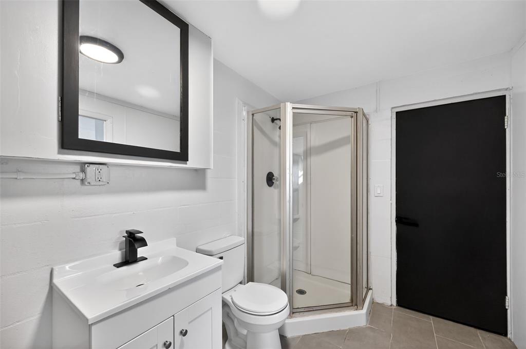 4086 Arrowhead Avenue Spring Hill, FL 34606 - Photo 16 of 21 a bathroom with a sink a toilet and a mirror