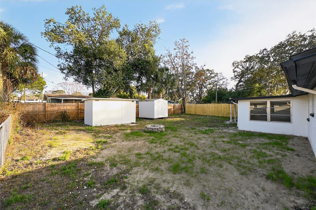 4086 Arrowhead Avenue Spring Hill, FL 34606 - Photo 20 of 21 a backyard of a house with barbeque oven and outdoor seating