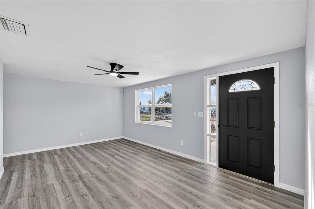 4086 Arrowhead Avenue Spring Hill, FL 34606 - Photo 4 of 21 wooden floor in an empty room with a window