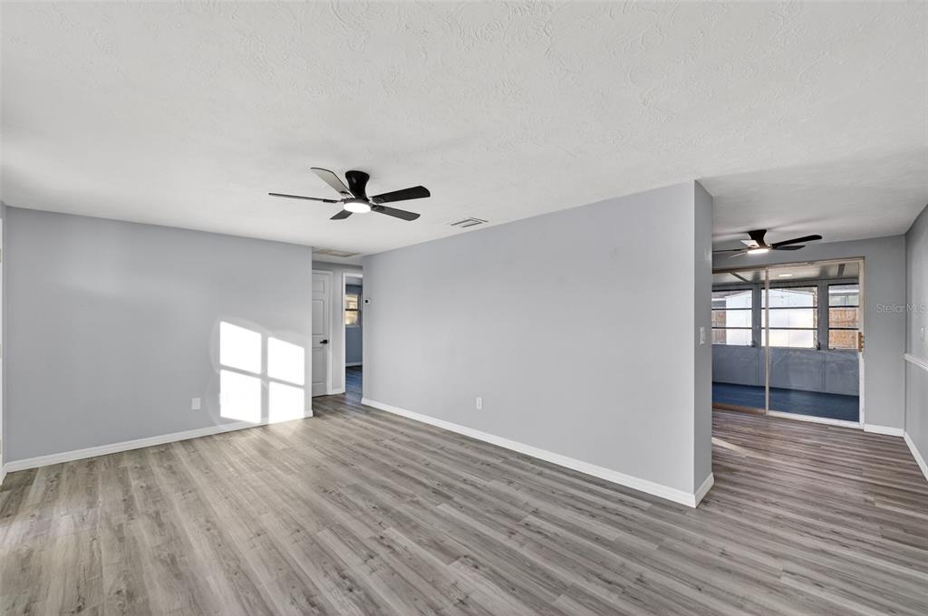 4086 Arrowhead Avenue Spring Hill, FL 34606 - Photo 6 of 21 a view of empty room with wooden floor and fan