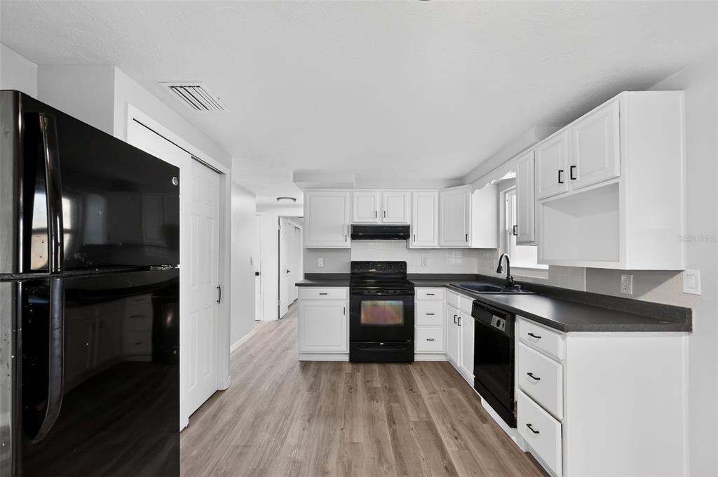 4086 Arrowhead Avenue Spring Hill, FL 34606 - Photo 8 of 21 a kitchen with a refrigerator and a stove top oven