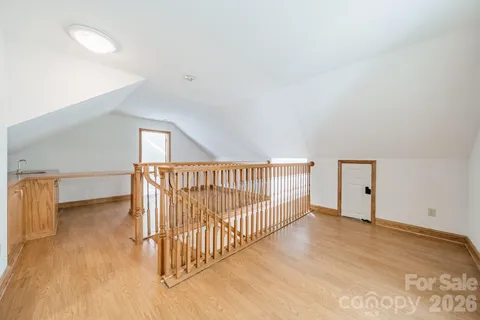 a view of a room with wooden floor