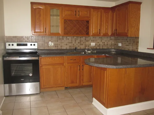 a kitchen with granite countertop a sink and a stove