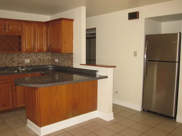 a kitchen with a refrigerator and a sink