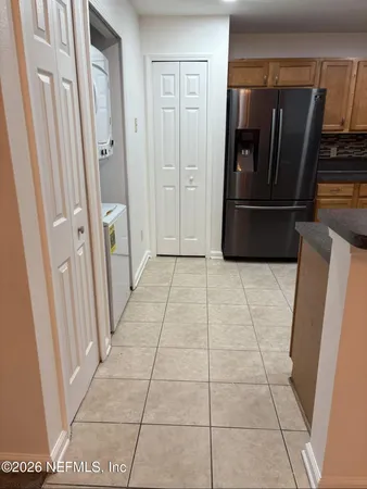an empty room with a window and a ceiling fan