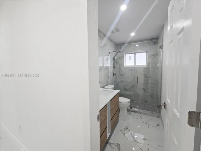 a view of a house with a tree and a yard