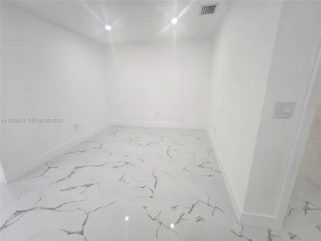 a view of a house with large trees