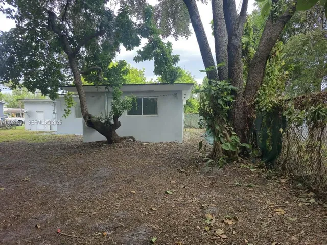 a view of a pathway of a house with a yard