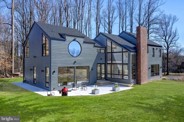 a view of a house with a yard and furniture