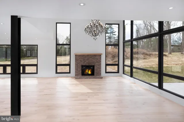 a view of an empty room with window and fire place