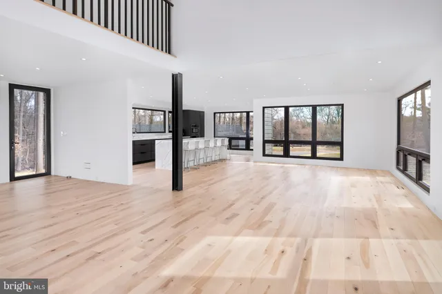 a view of a kitchen with an entryway and wooden floor