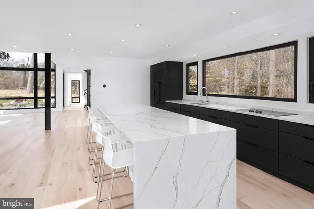 a kitchen with stainless steel appliances kitchen island wooden cabinets and window