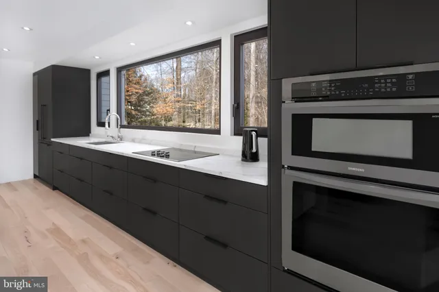 a kitchen with stainless steel appliances a stove sink and cabinets