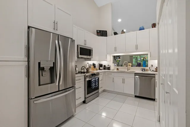 a kitchen with a refrigerator sink and microwave
