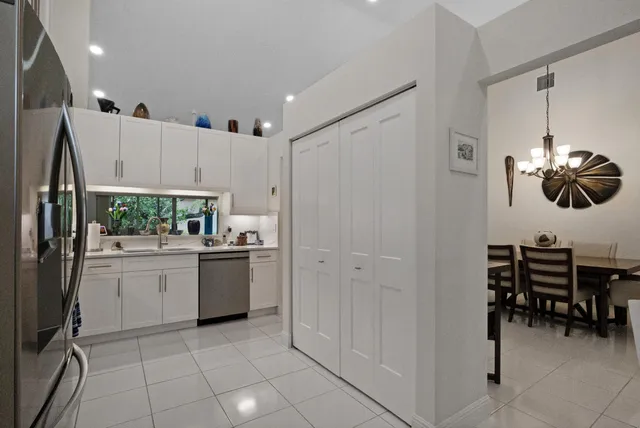 a kitchen with refrigerator and cabinets