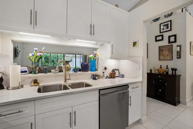 a kitchen with white cabinets and a sink
