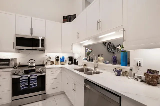 a kitchen with a sink a stove and cabinets