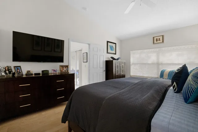 a bedroom with a bed and a flat screen tv