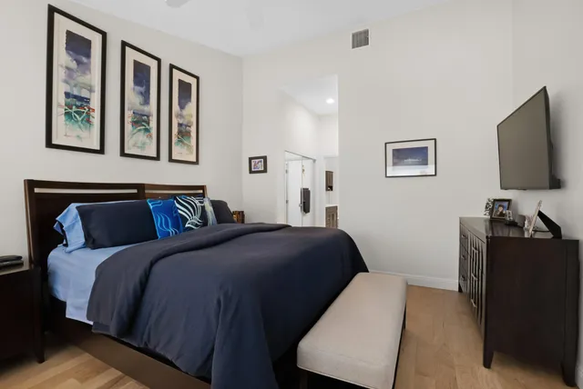 a bedroom with a bed and a flat screen tv