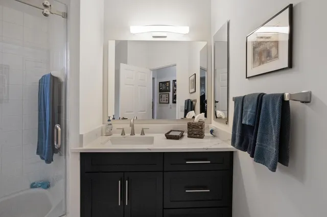 a bathroom with a sink vanity and a mirror
