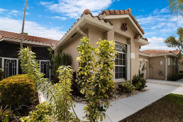 a view of a house with potted plants