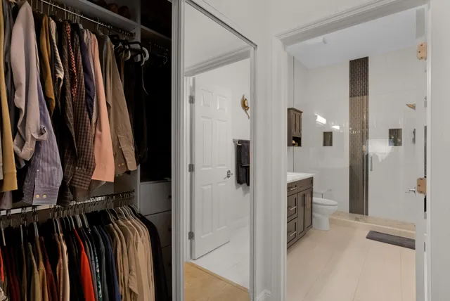 a view of walk in closet with clothes