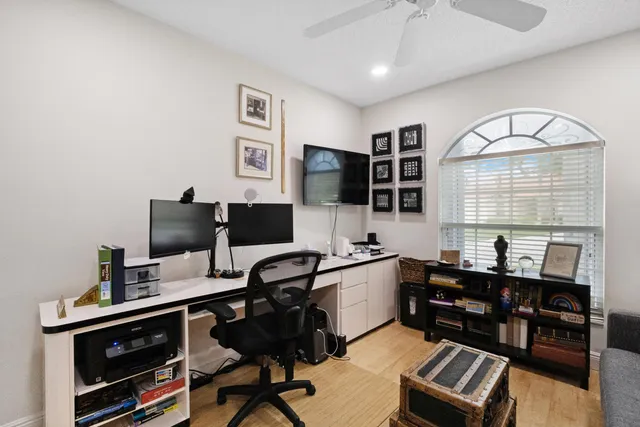 a view of a workspace with furniture and a window