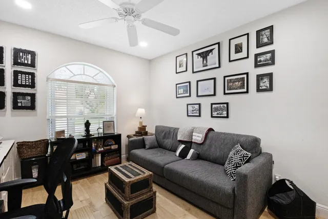a living room with furniture and large windows