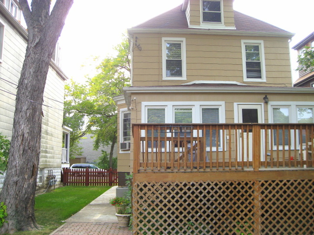4241 North Springfield Avenue Chicago, IL 60618 - Photo 17 of 19 a front view of a house with a garden