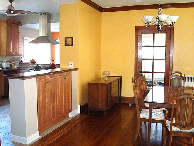4241 North Springfield Avenue Chicago, IL 60618 - Photo 6 of 19 a kitchen with stainless steel appliances granite countertop a stove top oven a dining table and chairs with wooden floor