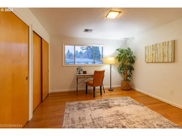 a view of a dining room with furniture and a window