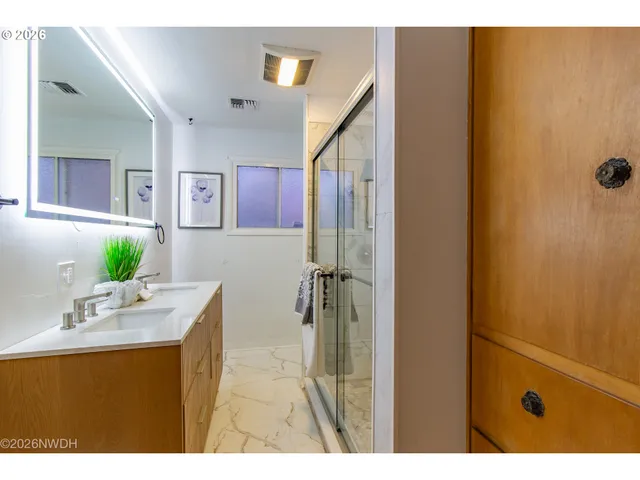 a bathroom with a sink vanity and mirror