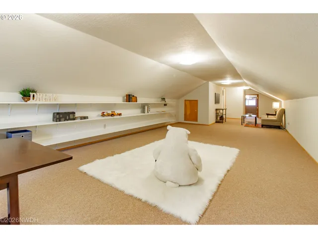 a view of a house with a big yard plants and large trees