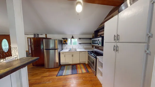 a kitchen with a sink stainless steel appliances and cabinets