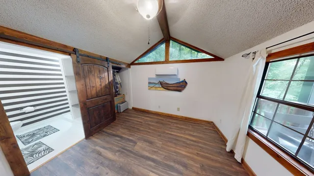 a view of empty room with wooden floor