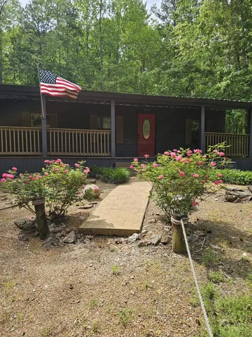 a wooden bench sitting in front of a house