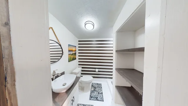 a kitchen with a refrigerator and a stove top oven