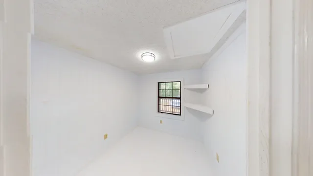 a view of hallway with wooden floor and staircase
