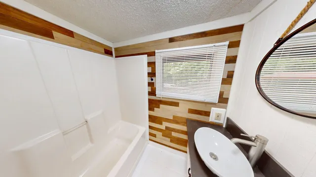 a bathroom with a tub and shower