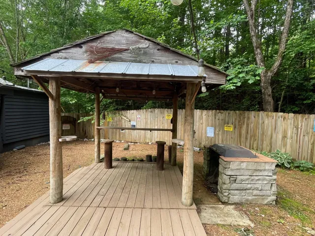 a view of a house with backyard and sitting area