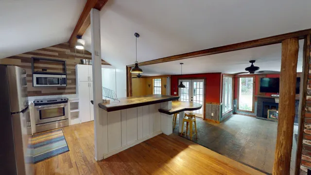 a view of a kitchen with furniture and wooden floor