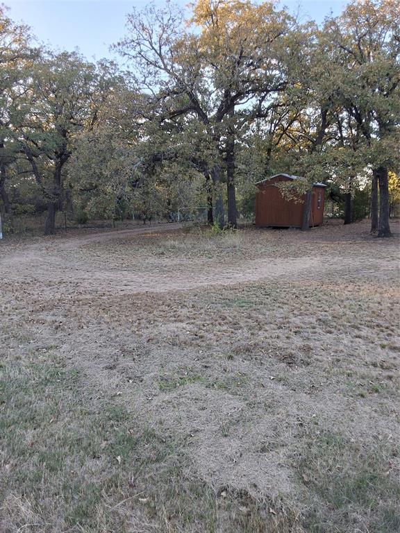 5765 Tokio Road West, TX 76691 - Photo 9 of 10 View of yard with a storage shed