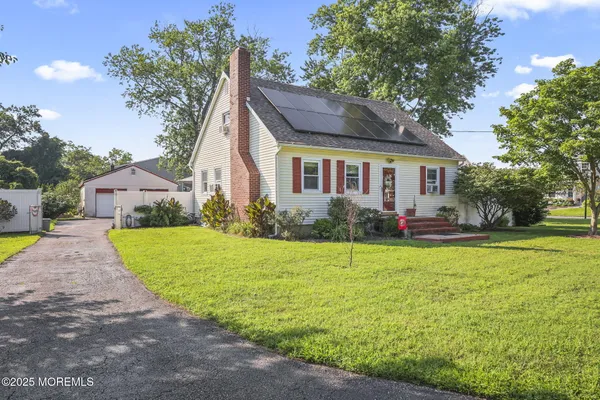 a front view of house with yard and green space
