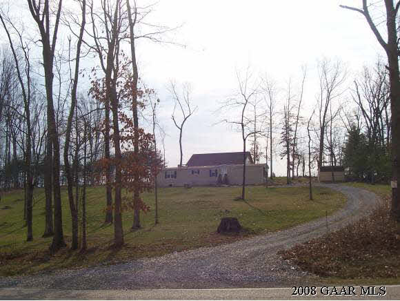 a view of a yard with wooden fence