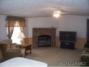 360 Steeles Fort Road Raphine, VA 24472 - Photo 6 of 10 a living room with furniture a flat screen tv and a fireplace
