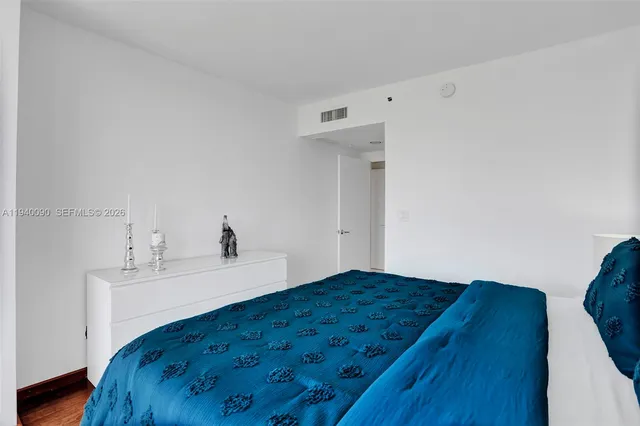 a bedroom with a bed and a sink